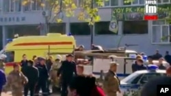 In this image made from video, showing the scene as emergency services load an injured person onto a truck, in Kerch, Crimea, Oct. 17, 2018.