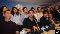 Pemimpin Partai Demokrat dan mantan Perdana Menteri Thailand Abhisit Vejjajiva (tengah) didampingi oleh para anggota partai saat berbicara dengan wartawan di Bangkok (8/12). (AP/Sakchai Lalit)