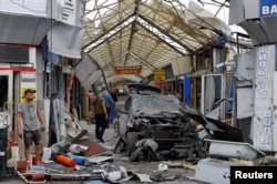 A view shows a destroyed car at a local market after the shelling, which local Russian-installed authorities called a Ukrainian military strike, in Russian-controlled Ukraine, Sept. 4, 2024.