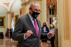 Senate Majority Leader Chuck Schumer of N.Y. walks off the Senate floor and pumps his fists as the Senate approves a $1 trillion bipartisan cornerstone of the Biden agenda to the House, on Capitol Hill in Washington, Aug. 10, 2021.