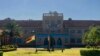 The Zimbabwean flag flies at half mast at Kutama College, a school where former Zimbabwean President Robert Mugabe studied in his rural home in Zvimba about 100 kilometres north west of the capital Harare, Friday, Sept, 27, 2019. 
