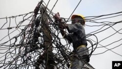 A worker of Nigeria Power works on power lines in Nigeria.