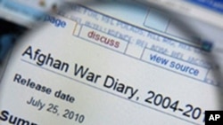 A magnifying glass held in front of a computer screen, displaying an Afghan War Diary on the Wikileaks website, 26 July 2010
