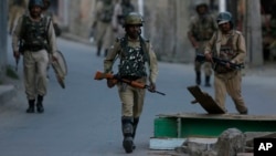 Indian paramilitary soldiers return to their base camp as they lift restrictions in Srinagar, Indian controlled Kashmir, July 8, 2018. 