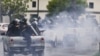 En esta imagen de archivo, del 28 de mayo de 2018, policías con equipo antimotines, montados en la parte trasera de camionetas, disparan a estudiantes que protestaban contra el presidente de Nicaragua, Daniel Ortega, en Managua. (Foto AP/Esteban Félix, archivo)