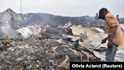 Des habitants inspectent les dégâts de leurs maisons détruites par la lave du volcan Nyiragongo près de Goma, en République démocratique du Congo, le 23 mai 2021. 