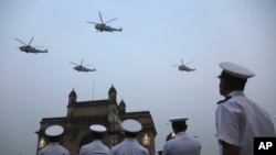 FILE - Indian navy personnel display their skills during a rehearsal for Naval Day celebrations near the Gateway of India monument in Mumbai, India, Dec. 1, 2019. 