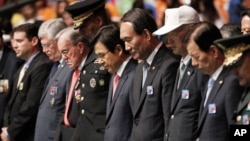 South Korea's Prime Minister Hwang Kyo-ahn, center, pays a silent tribute during a commemorative ceremony marking the 63rd anniversary of the Armistice Agreement and UN Forces Participation in the Korean War in Seoul, South Korea on July 27, 2016. 