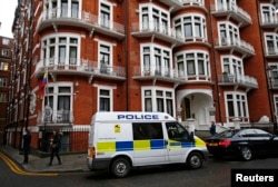 A police van waits outside the Ecuadorian embassy in central London, Britain, Feb. 5, 2016.