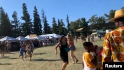 People run as an active shooter was reported at the Gilroy Garlic Festival, south of San Jose, California.