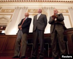 FILE - Apollo 11 astronauts Neil Armstrong, Michael Collins (L) and Buzz Aldrin (R) stand during a recognition ceremony at the U.S House of Representatives.