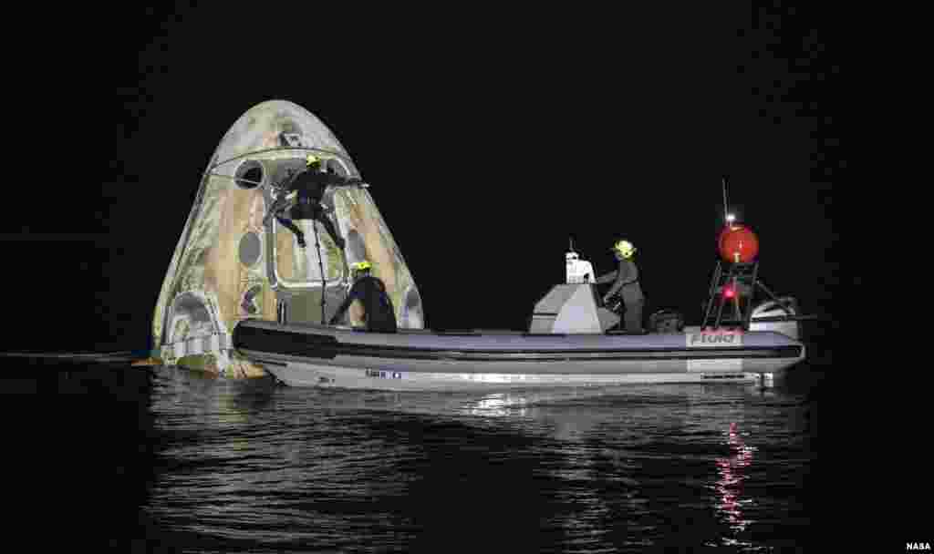 Support teams work around the SpaceX Crew Dragon Resilience spacecraft shortly after it landed with NASA astronauts Mike Hopkins, Shannon Walker, and Victor Glover, and Japan Aerospace Exploration Agency (JAXA) astronaut Soichi Noguchi aboard in the Gulf of Mexico off the coast of Panama City, Florida.