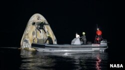 Support teams work around the SpaceX Crew Dragon Resilience spacecraft shortly after it landed with NASA astronauts Mike Hopkins, Shannon Walker, and Victor Glover, and Japan Aerospace Exploration Agency (JAXA) astronaut Soichi Noguchi aboard in the Gulf of Mexico off the coast of Panama City, Florida.