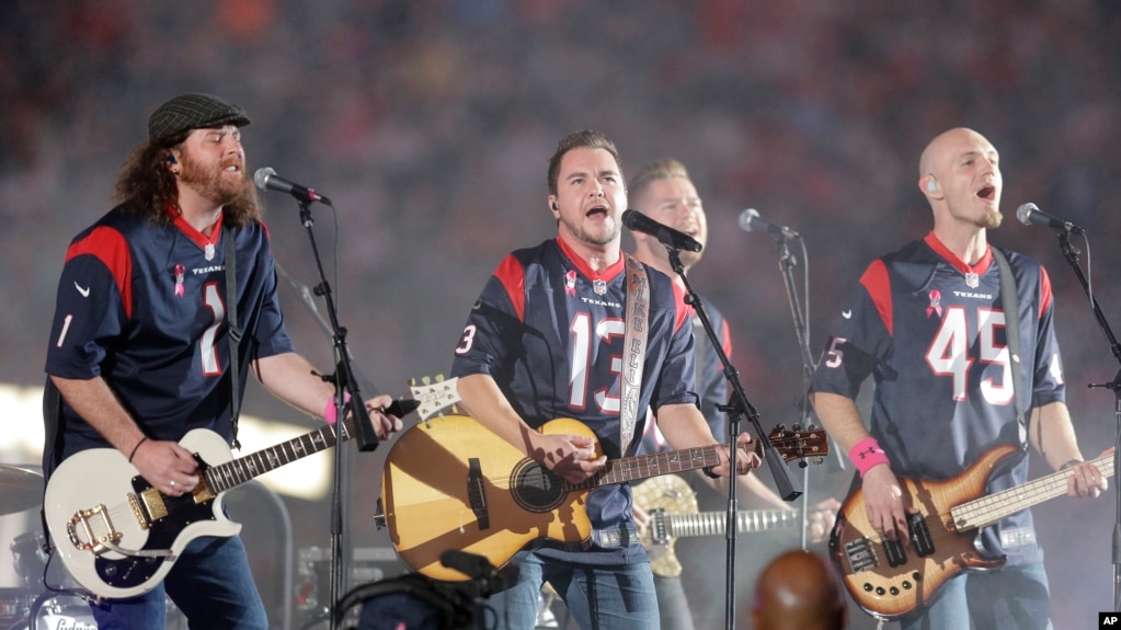 FILE - This Oct. 9, 2014 file photo shows The Eli Young Band performing during halftime of an NFL football game in Houston. The band will perform as part of the Concert in Your Car series at the new Texas Rangers stadium in Arlington, Texas starting June June 4. (AP Photo)
