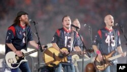 FILE - This Oct. 9, 2014 file photo shows The Eli Young Band performing during halftime of an NFL football game in Houston. The band will perform as part of the Concert in Your Car series at the new Texas Rangers stadium in Arlington, Texas starting June June 4. (AP Photo)