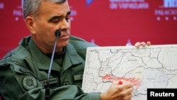 El ministro de Defensa de Venezuela, Vladimir Padrino López, marca el área donde se encuentran desplegadas la Fuerza Armada en un mapa del estado de Apure durante una conferencia de prensa en el Palacio de Miraflores, en Caracas, el 11 de febrero de 2022. 