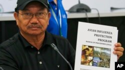  Department of Agriculture Secretary Emmanuel Pinol holds a manual for Avian Influenza Protection during a news conference, Aug. 11, 2017 in Manila, Philippines. Pinol said the Philippines will cull 600,000 birds after confirming its first bird flu outbre