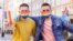 Gay couple Dawid Mycek and Jakub Kwiecinski pose with the rainbow-patterned face masks on a street in Gdansk, Poland, April 8, 2020. 