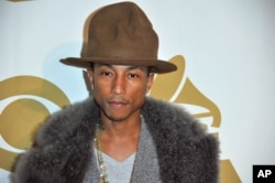 Pharrell Williams arrives at "The Night That Changed America: a Grammy Salute to the Beatles," Jan. 27, 2014, in Los Angeles