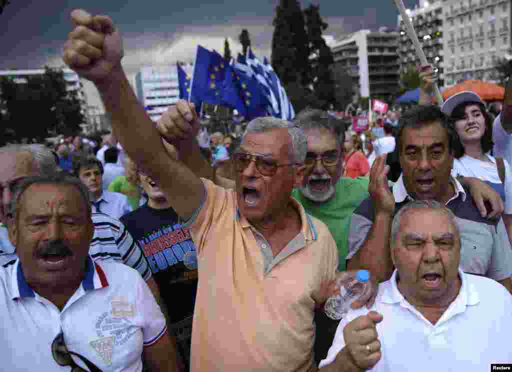 Warga yang mendukung keikutsertaan Yunani dalam zona Euro melakukan unjuk rasa di depan parlemen di Athena, Selasa (30/6). (Reuters/Marko Djurica)