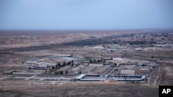 FILE - This photo, taken from a helicopter, shows Ain al-Asad air base in the western Anbar desert, Iraq, Dec. 29, 2019.