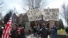 FILE - Protesters gather outside Minnesota Gov. Tim Walz's official residence in St. Paul, Minn., April 17, 2020, to call on him to loosen stay-at-home restrictions.