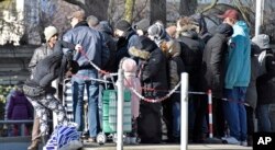 People wait in front of the food bank "Tafel" for free food in Essen, Germany, Feb. 24, 2018. Essen's division of the charitable organization announced not to take any new migrant customers because their number rises up to 75 percent and would block out needy elderly German people.