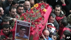 People carry the coffin of Berkin Elvan, a Turkish teenager who was in a coma since being hit on the head by a tear gas canister fired by police during anti-government protests in the summer of 2013, during his funeral in Istanbul, Turkey, March 12, 2014