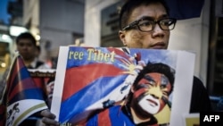 Rights group activists stage a protest to raise awareness on the human rights situation in Tibet and the closure of the territory to foreign visitors, outside the Chinese liaison office in Hong Kong, June 20, 2012. 