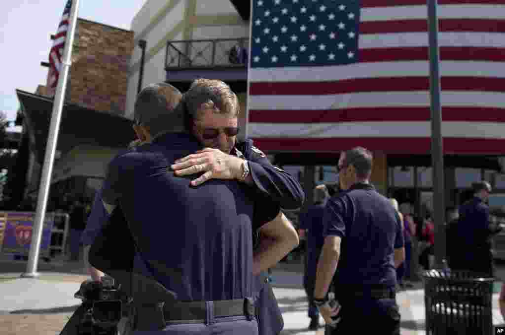 Linh mục Bob Ossler, phải, tuyên úy của đội cứu hỏa, chào đón các nhân viên cứu hỏa từ khắp nước Mỹ về dự lễ tưởng niệm.