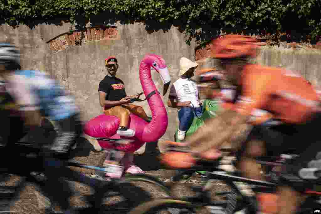 A supporter dressed as a flamingo cheers on the riders during the 12th stage of the 102nd Giro d&#39;Italia - Tour of Italy - cycle race, 158kms from Cuneo to Pinerolo.