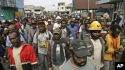Protesters from Freeport-McMoRan Copper & Gold Inc.'s Grasberg mine march during a demonstration in Timika of Indonesia's Papua province, October 10, 2011.