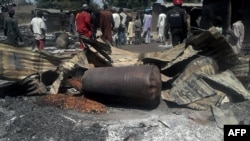 Des policiers déployés après une explosion dans le village de Konduga, dans le nord-est du Nigéria, le 12 février 2014.