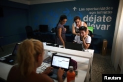 People work at the media platform OnCuba office in Havana, Cuba, Aug. 2, 2016.