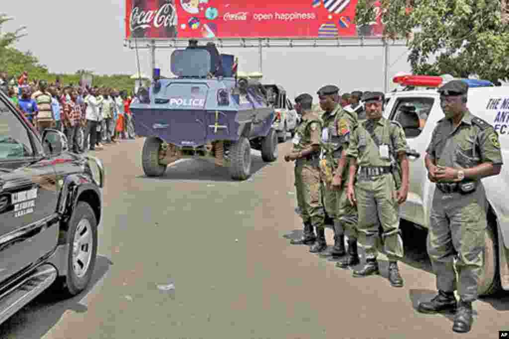 Nigerian bomb squad members stand guard in Kano, northern Nigeria, following the release of the presidential elections results, April 18, 2011. Rioting erupted across Nigeria's largely Muslim north on Monday and the Red Cross said many people were killed