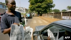 A man checks headlines of Sierra Leonean newspapers in Freetown. File photo.