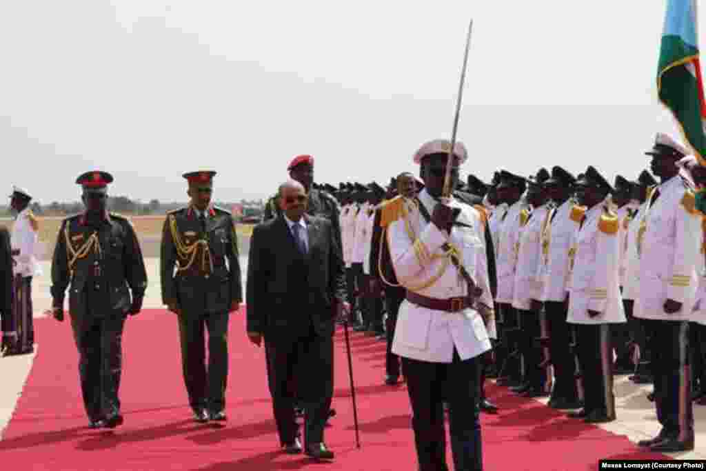 Sudanese President Omar al Bashir inspects an honor guard at Juba airport at the start of his first visit to South Sudan.
