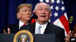President Donald Trump listens to Agriculture Secretary Sonny Perdue during a signing ceremony for H.R. 2, the "Agriculture Improvement Act of 2018," in the Eisenhower Executive Office Building, on the White House complex, Dec. 20, 2018, in Washington. 