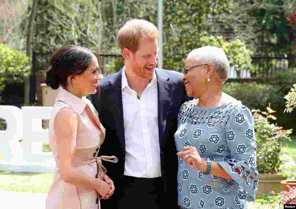 Britain&#39;s Prince Harry and his wife Meghan, the Duke and Duchess of Sussex, meet Graca Machel, the widow of Nelson Mandela, in Johannesburg, South Africa.