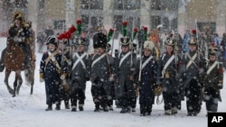 Historical re-enactors dressed as 1812-era French soldiers march during a re-enactment of the French Invasion of Russia during celebrations to mark the Russian Orthodox Christmas in St. Petersburg, Russia, January 7, 2013. 
