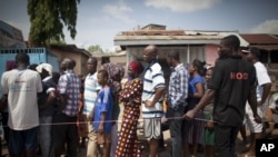FILE - People wait in line to vote at a polling station in Accra, Ghana, Dec. 8, 2012.