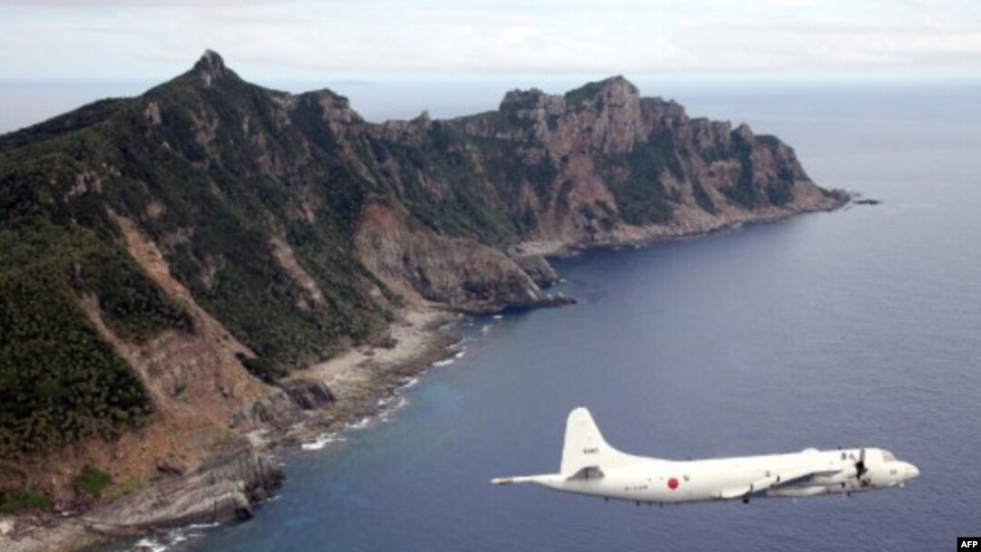 (File) This photo from Oct. 13, 2011, shows Japanese Maritime Self-Defense Force plane flying over the disputed islets known as the Senkaku islands in Japan and Diaoyu islands in China, in the East China Sea.