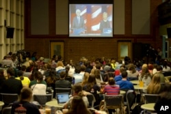 Students view on a video screen the Democratic presidential debate between candidates Senator Bernie Sanders of Vermont and former Secretary of State Hillary Clinton at University of New Hampshire in Durham, N.H., Feb. 4, 2016.