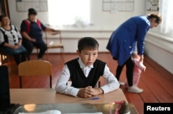 Ravil Izhmukhametov, 9, attends a class with teacher Uminur Kuchukova, 61, on the first day of the new school year in the village of Sibilyakovo, Omsk region, Russia, September 2, 2019.
