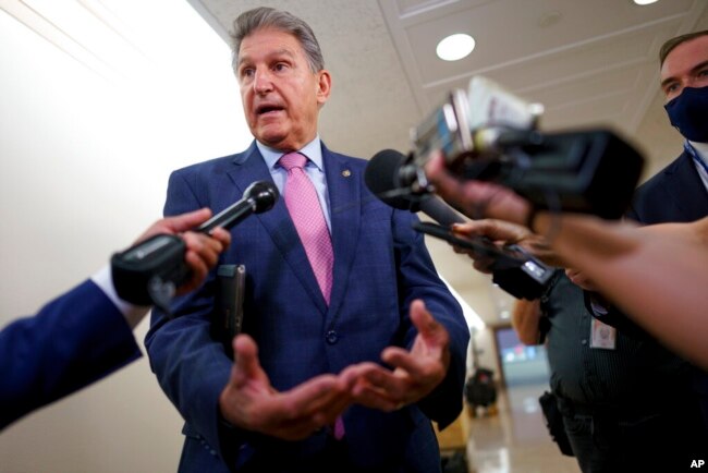 FILE - Sen. Joe Manchin, D-W.Va., talks to reporters as he arrives at the Capitol in Washington, Oct. 5, 2021.