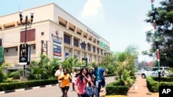 People run from the Westgate Mall in Nairobi, Kenya, Sept. 21 2013, after gunmen threw grenades and opened fire during an attack.