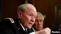 Chairman of the Joint Chiefs, Gen. Martin Dempsey, beside U.S. Secretary of Defense Chuck Hagel during defense subcommittee of the Senate Appropriations Committee, Washington, June 18, 2014.