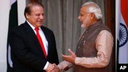 Indian Prime Minister Narendra Modi, right, shakes hand with his Pakistani counterpart Nawaz Sharif before the start of their meeting in New Delhi, India, May 27, 2014.