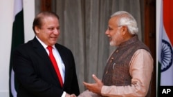FILE - India's Prime Minister Narendra Modi (R) shakes hands with his Pakistani counterpart Nawaz Sharif before the start of their bilateral meeting in New Delhi May 27, 2014. 
