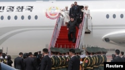 North Korean leader Kim Jong Un walks down from his airplane as he arrives for a visit in Dalian, China in this undated photo released on May 9, 2018 by North Korea's Korean Central News Agency (KCNA). 